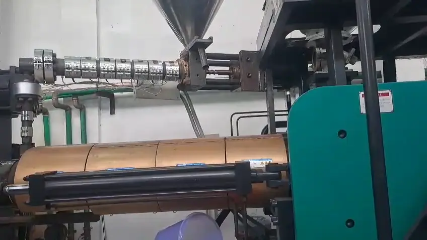 Screw and barrel of an injection unit with heater bands fitted