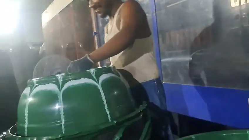 Green two colour bucket coming out of the mould made with a two colour attachment