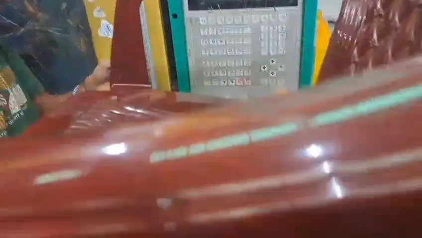 Close up of the wood grain finish on a plastic chair coming off the mould