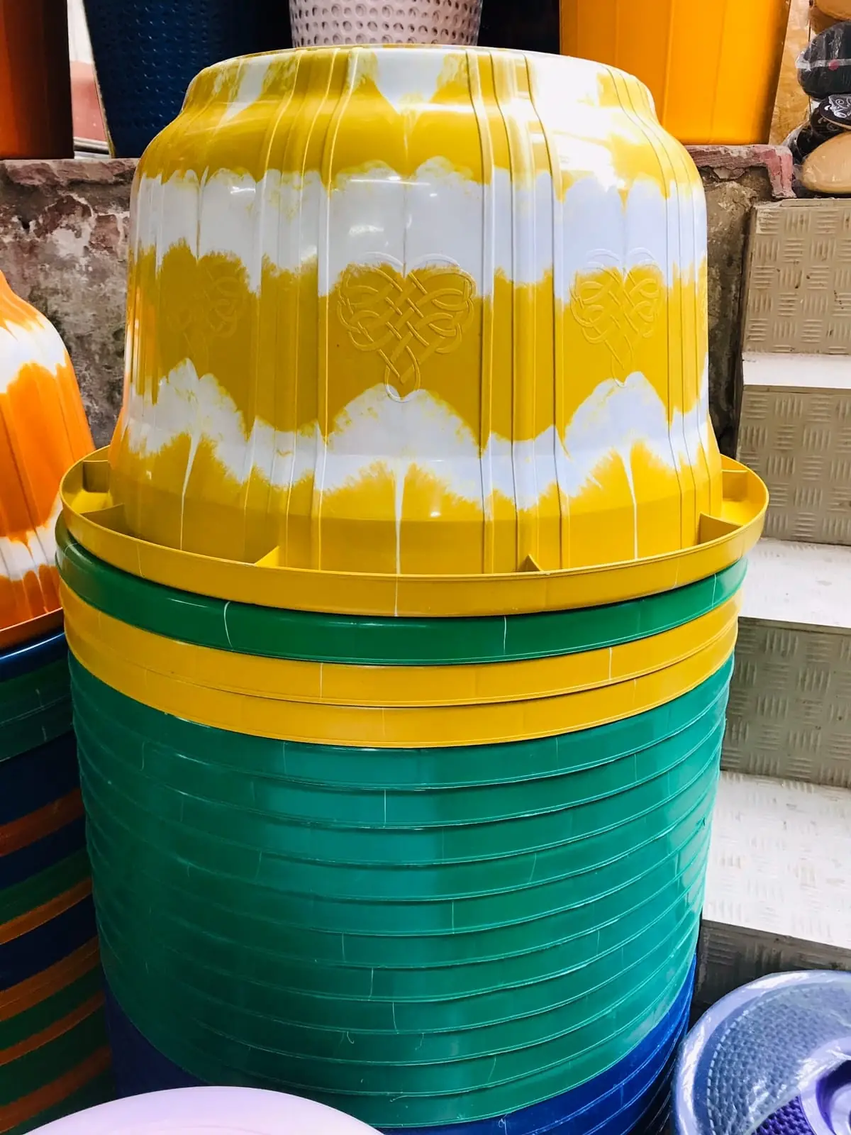 Stack of yellow and green two colour tubs made with a two colour attachment